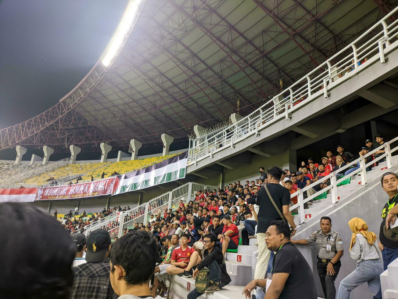 Surabaya, indonesia - 22 june 2023 - A view and atmosphere with many indonesia supporter at gelora bung tomo. Indonesia vs palestina friendly match. photo