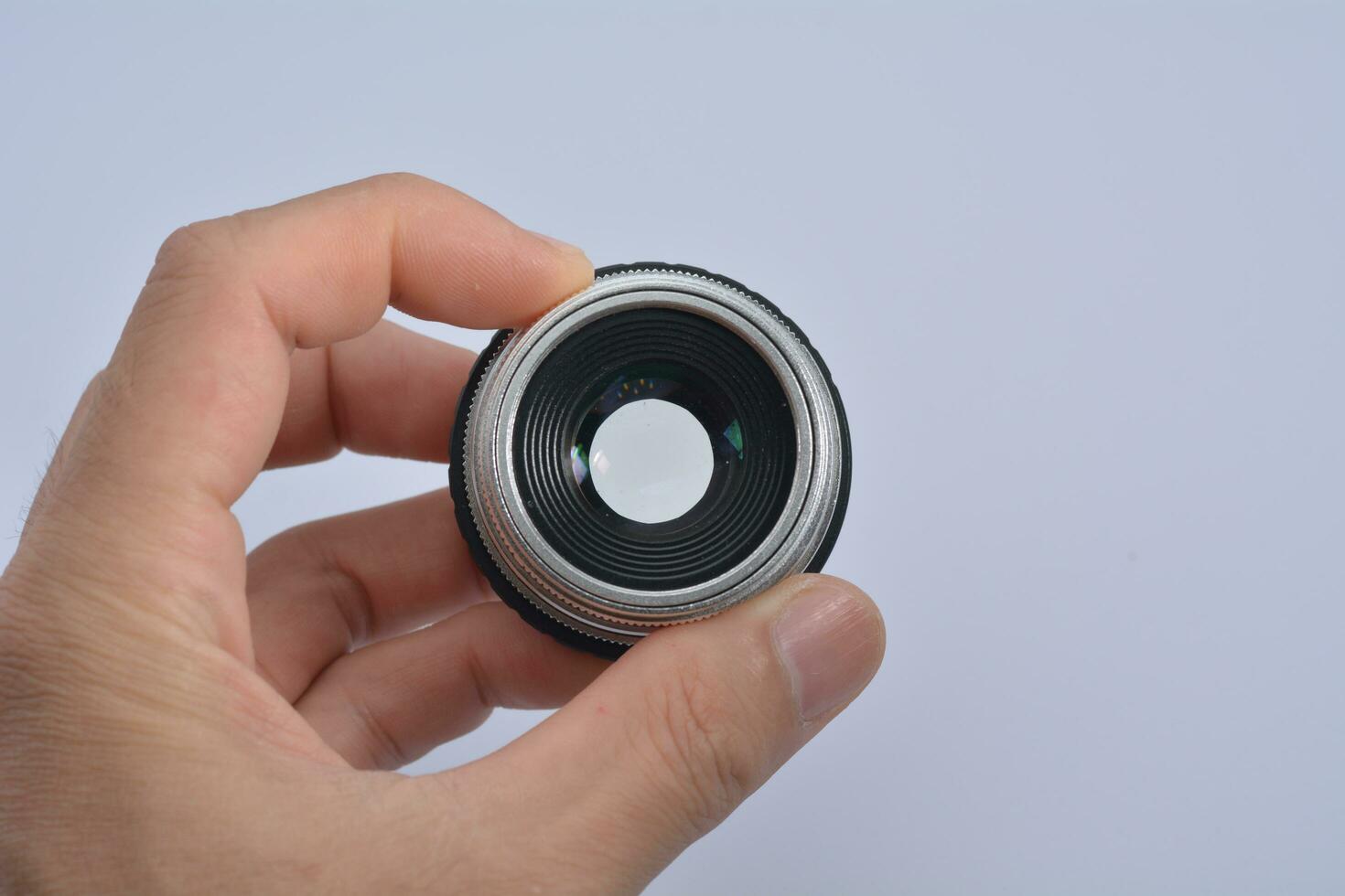 camera lens on hand on a white background photo