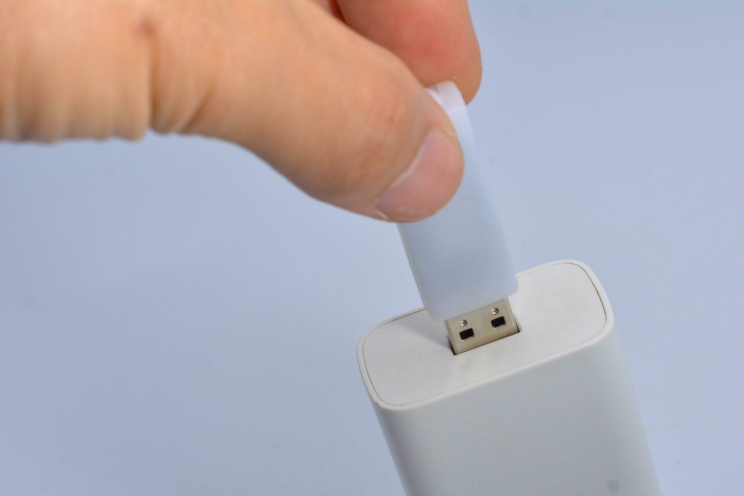 Connecting a thumb drive, white background photo