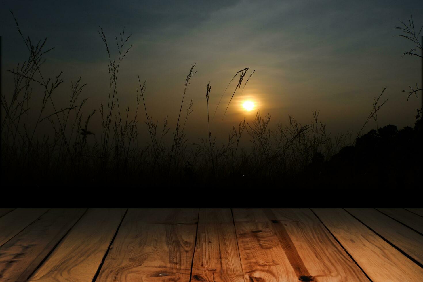 Wood board above empty table on sunset background. Brown wooden table can be used mock-up for display of montage products or key visual layout designs photo