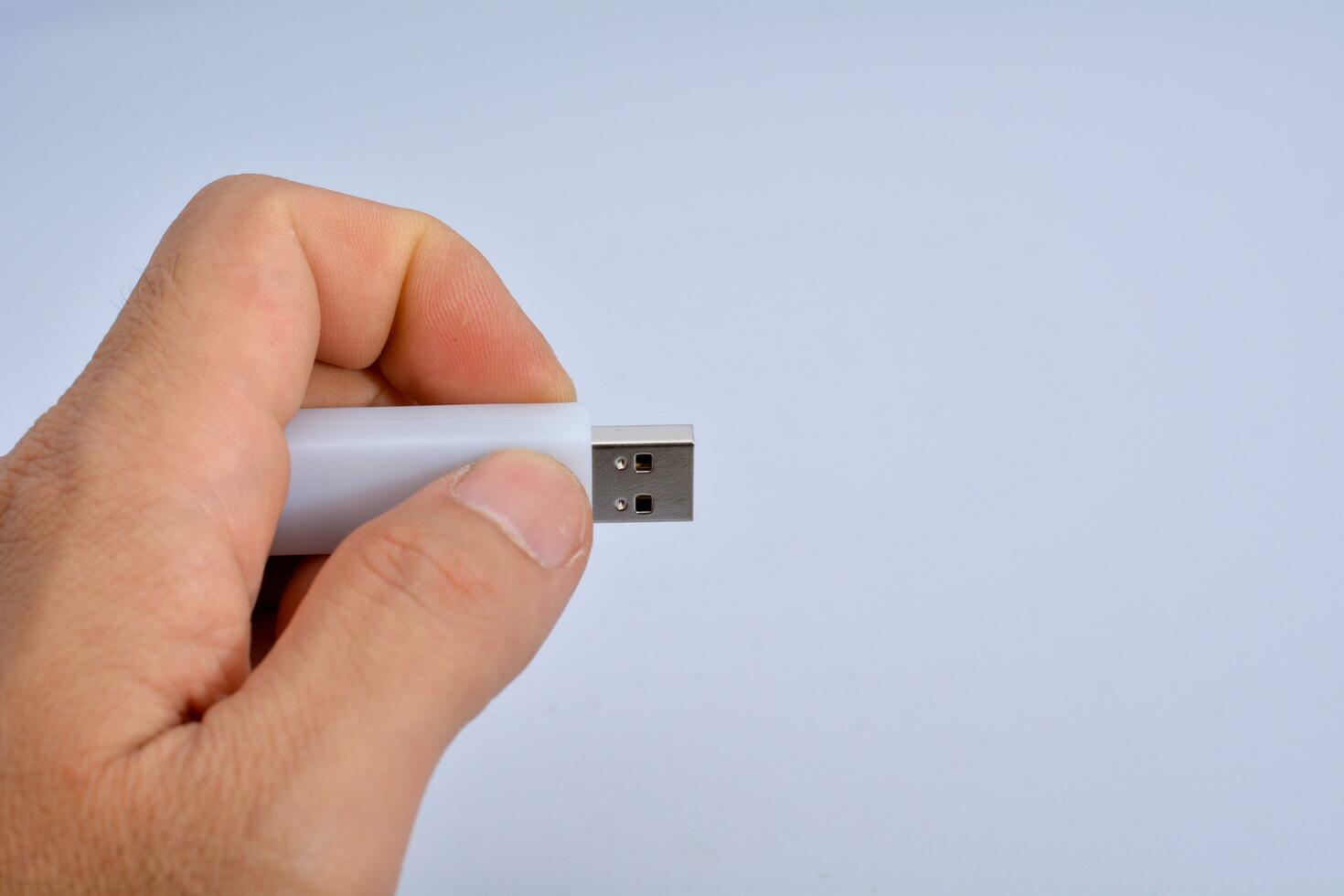 Thumb drive on hand, white background photo