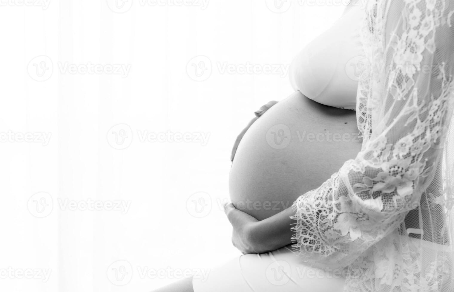 Portrait of a pregnant woman touching her big belly close up, mother, pregnancy, people and expectation. Woman holding big pregnant stomach photo