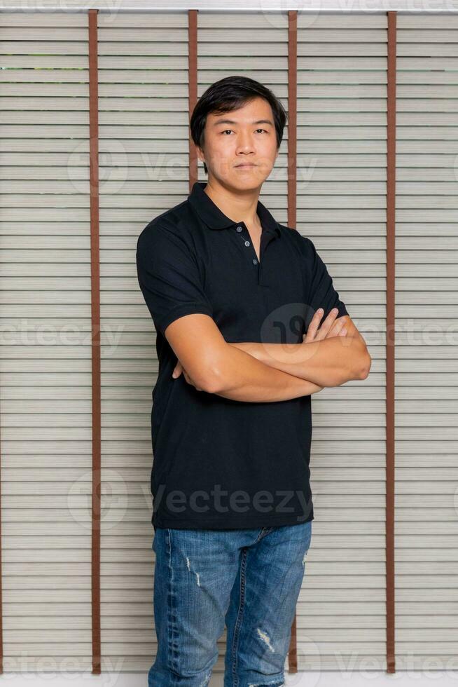 Portrait of a man Asian standing in black t-shirt and shorts. Isolated  on background with copy space and clipping path photo