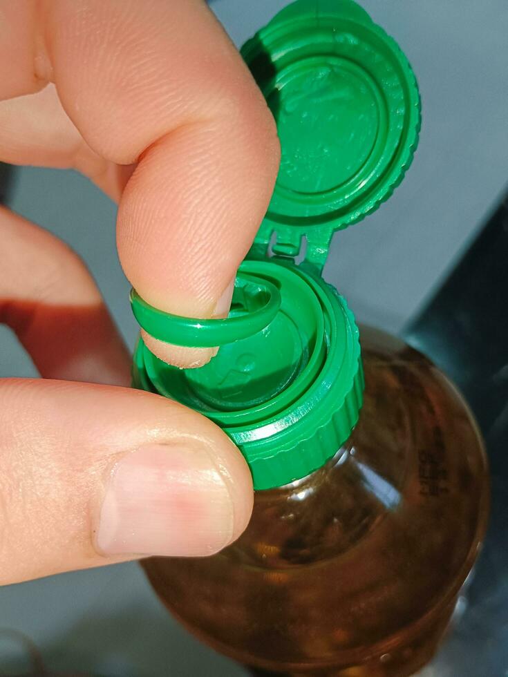 Open Cap Of Vegetable Oil Bottle Before Cooking photo