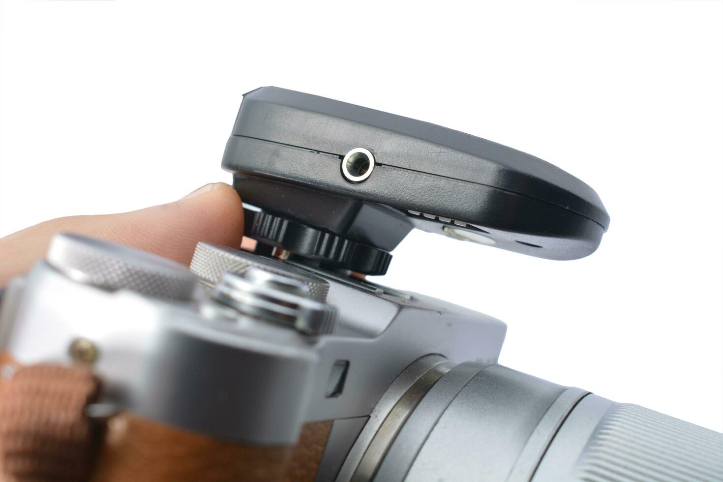 mirrorless camera and flash trigger isolated white background photo