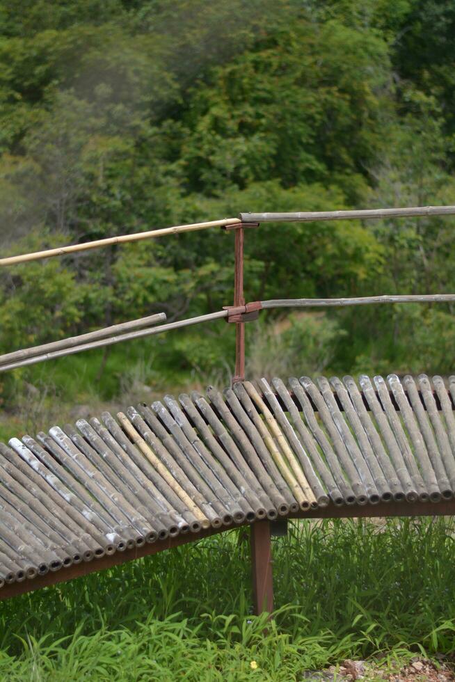 Bamboo bridge on the top of the mountain green grass background photo