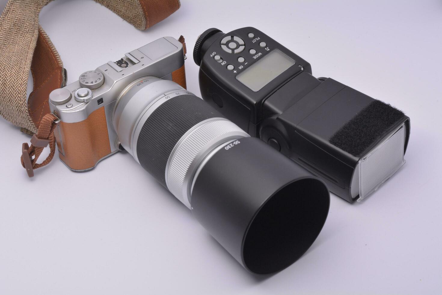 Camera and camera strap on white background photo
