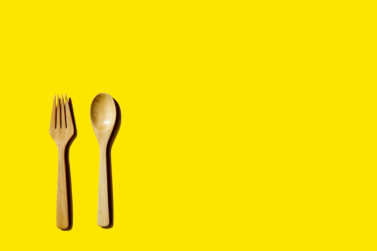 wooden spoon and fork, light and shadow Top view with space for your recipes. photo
