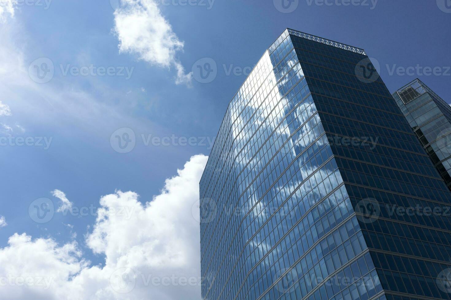 Skyscrapers, High-rise Building From Angle View On Background Of Sky. Cityscape, Tower In Urban Area. Business Development Or Financial Center Concept. Copy Space On Left. Modern Building. Horizontal photo