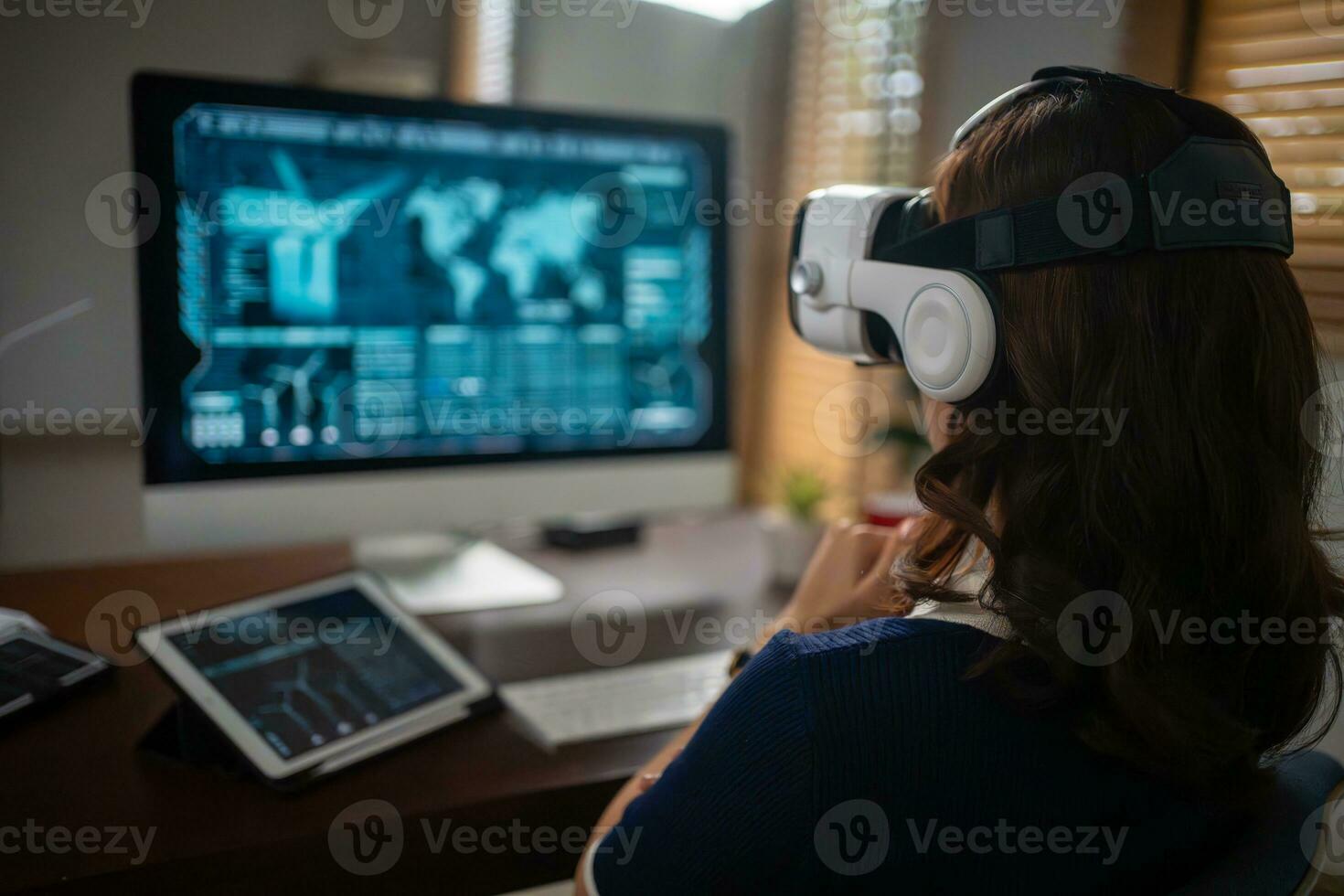 Futuristic women Engineer Wearing Virtual Reality Glasses working with a futuristic hologram to analysis and create alternative energy solutions with wind turbines photo