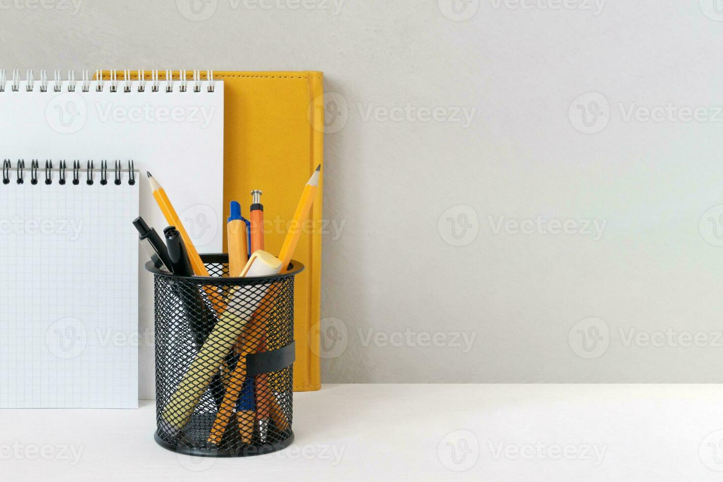 Stationery on the table near the gray wall. Place of study, copy space. photo
