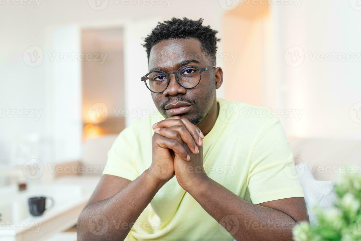 Close up profile view of pensive upset African American man look in distance thinking of personal problems, thoughtful sad biracial male feel depressed lost in thoughts pondering, having dilemma photo