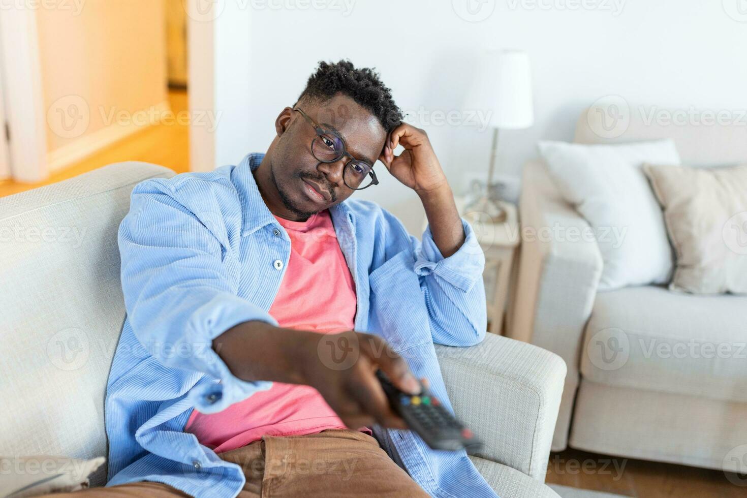 Excited African American Man Pointing Television Controller To Camera Switching Channels Watching TV . Television Programming Advertisement. Selective Focus photo