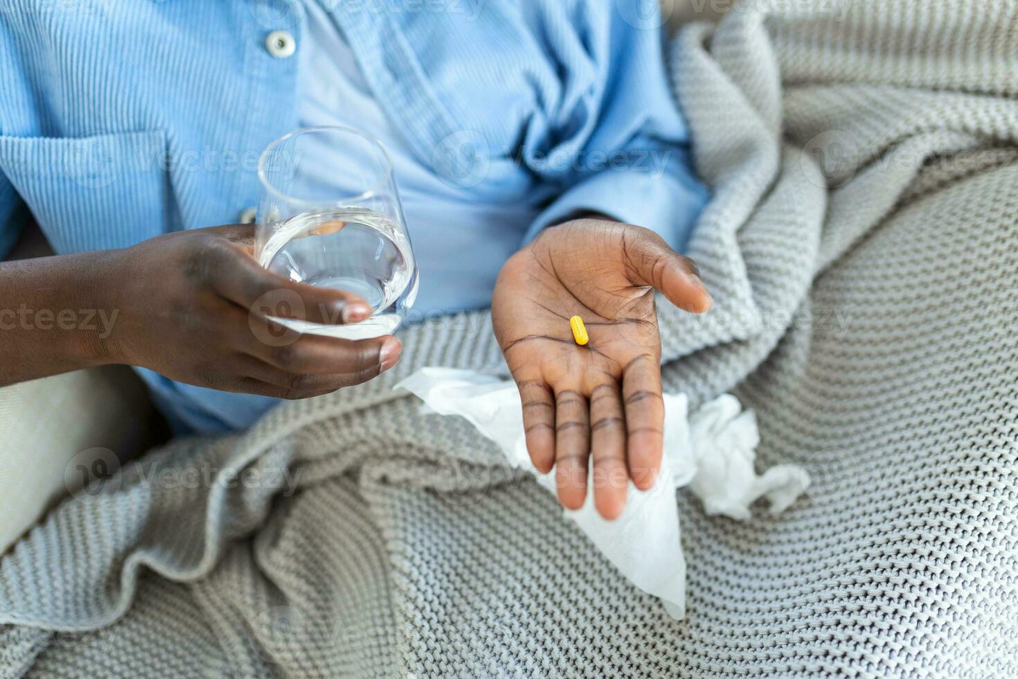 Black man hold pills and jar in his hands. Concept of healthcare and medicine, patient take daily dose of prescribed medicament, feel sick, antibiotics, painkillers or antidepressants. Close up photo