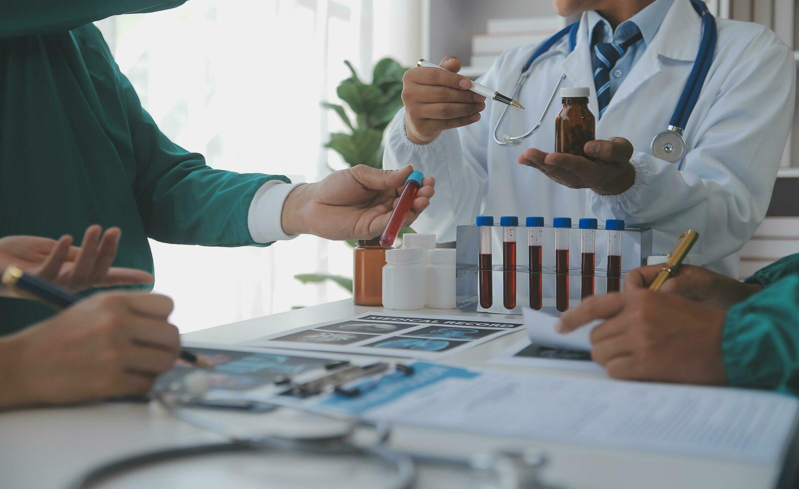 Medical technology network team meeting concept. Doctor hand working smart phone modern digital tablet laptop computer graphics chart interface, sun beams effect photo