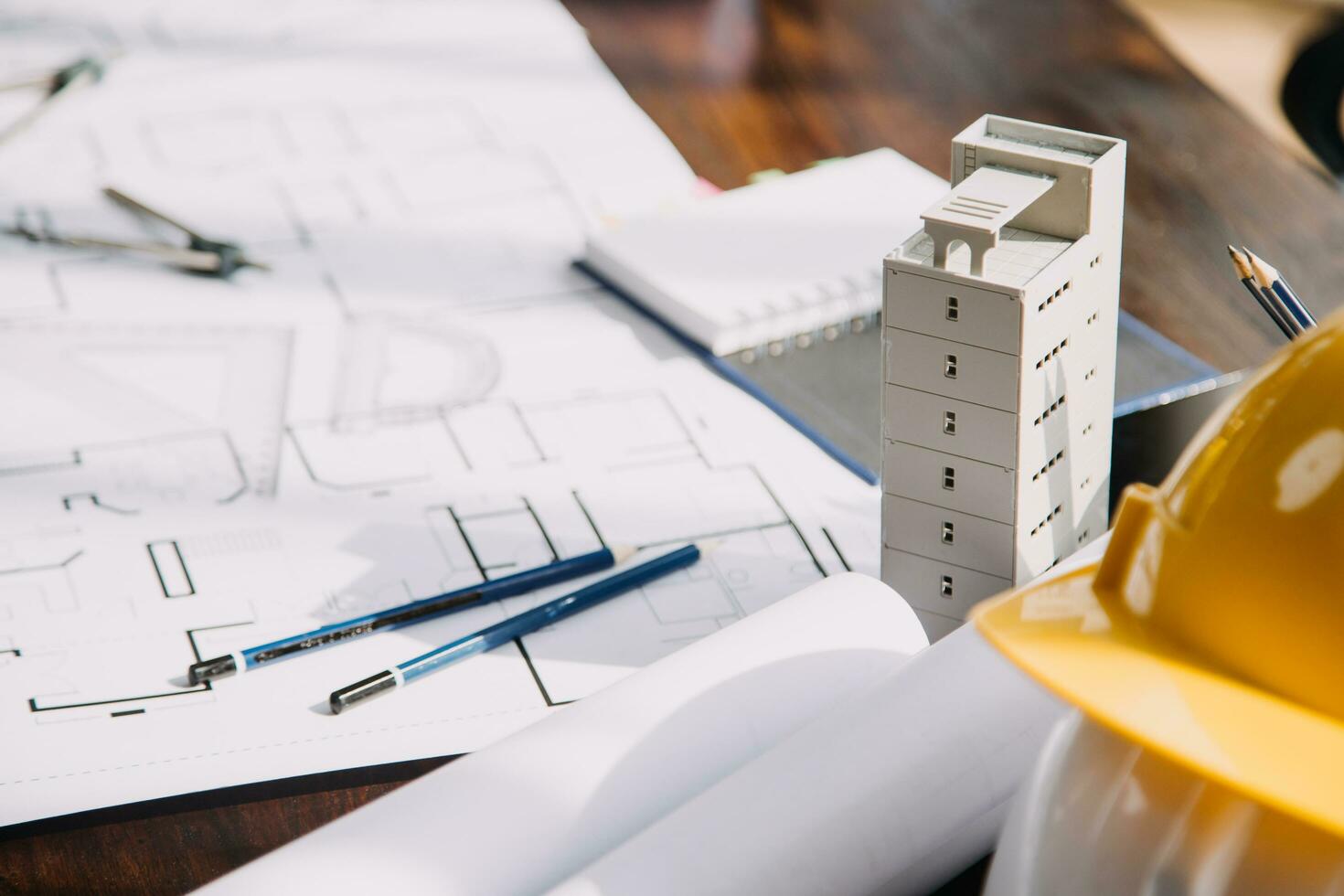 Construction and structure concept of engineer working drawing on blueprint meeting for project working with partner on model building and engineering tools in working site, construction concept. photo