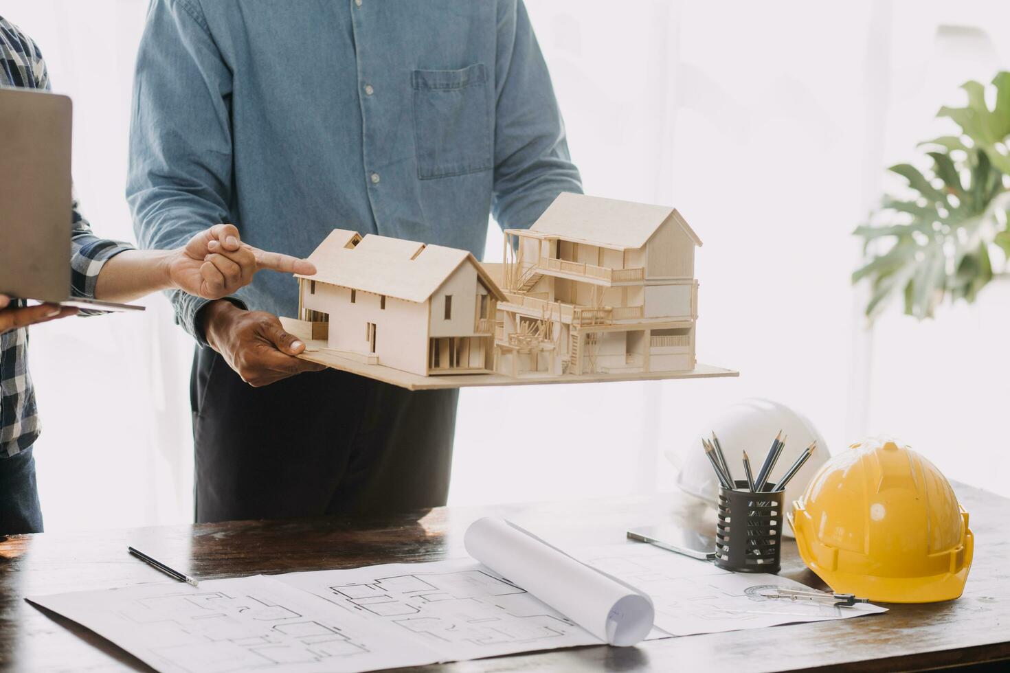 Construction and structure concept of engineer working drawing on blueprint meeting for project working with partner on model building and engineering tools in working site, construction concept. photo
