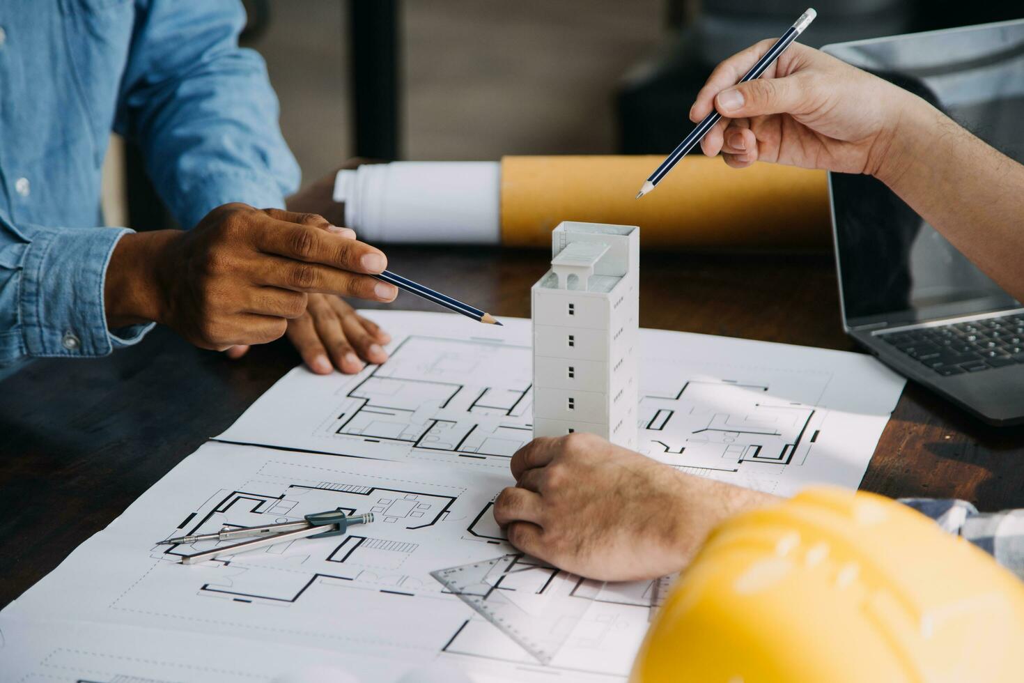 Construction and structure concept of engineer working drawing on blueprint meeting for project working with partner on model building and engineering tools in working site, construction concept. photo