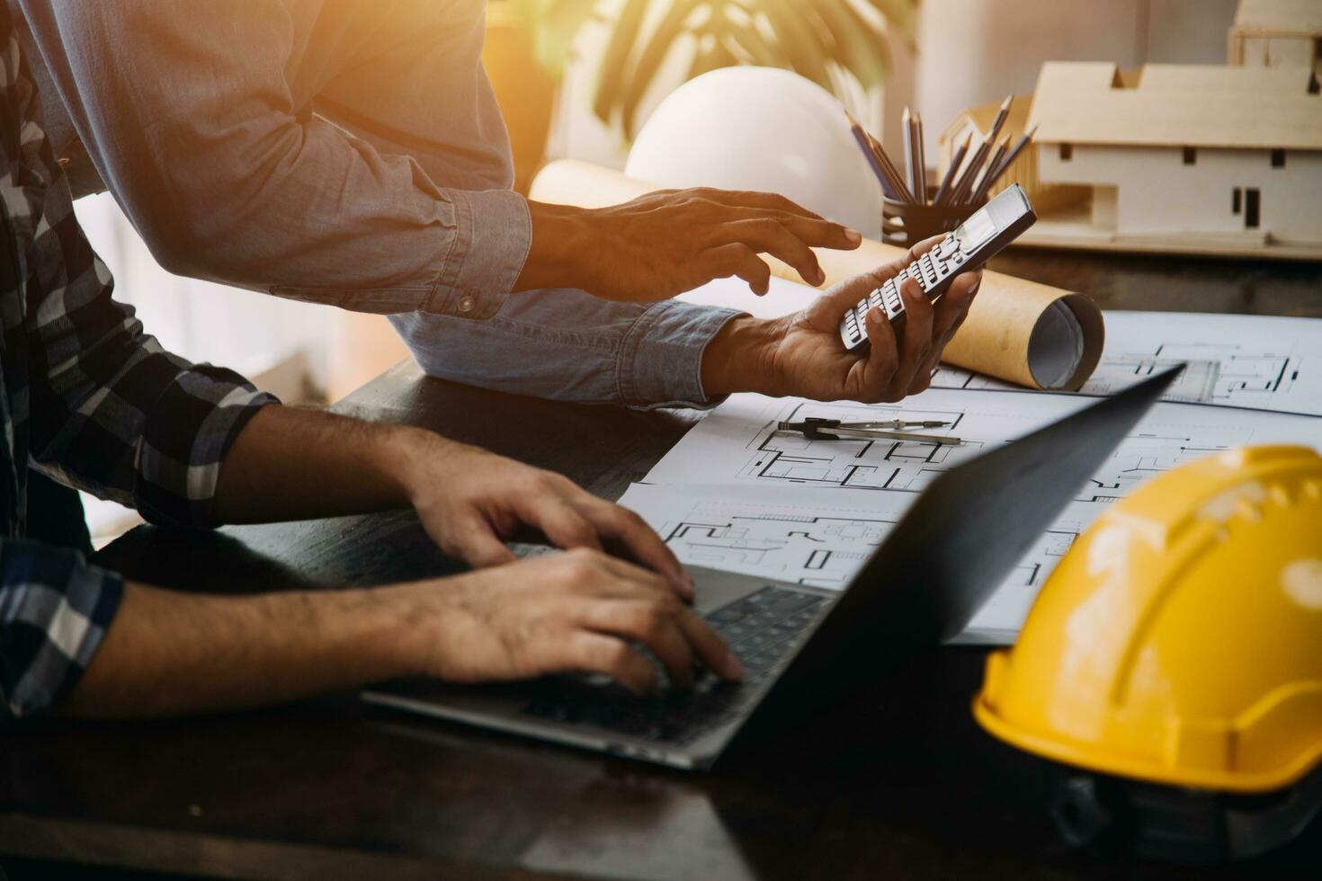 Construction and structure concept of engineer working drawing on blueprint meeting for project working with partner on model building and engineering tools in working site, construction concept. photo