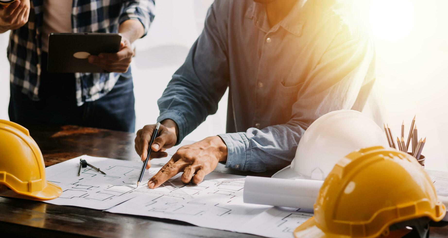 Engineer Teamwork Meeting, Drawing working on blueprint meeting for project working with partner on model building and engineering tools in working site, Construction and structure concept. photo