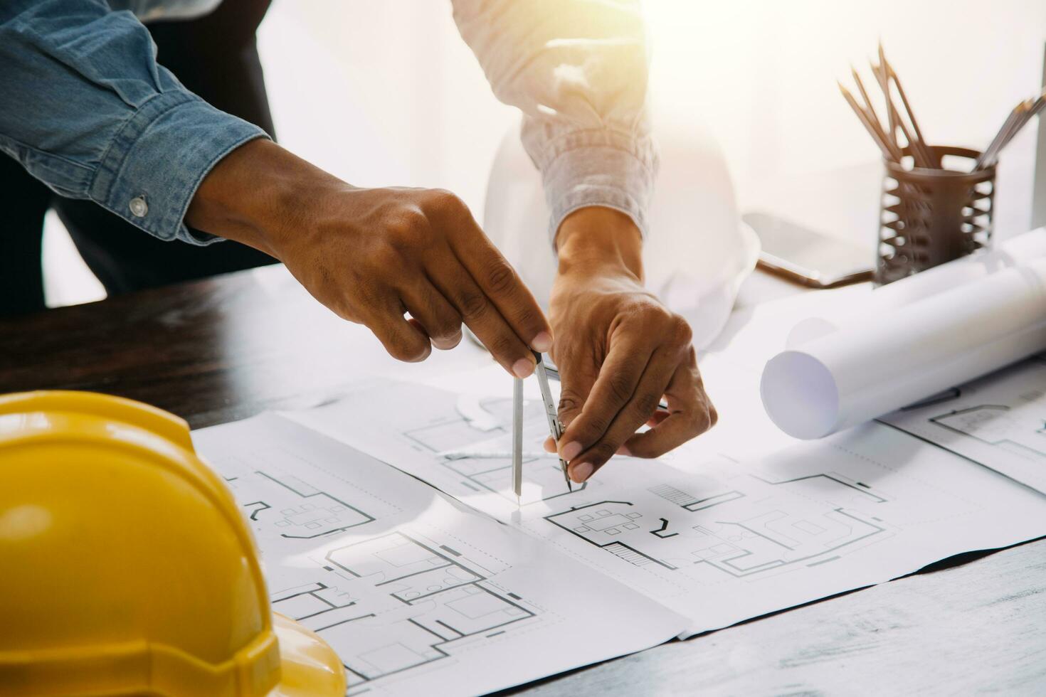Engineer Teamwork Meeting, Drawing working on blueprint meeting for project working with partner on model building and engineering tools in working site, Construction and structure concept. photo