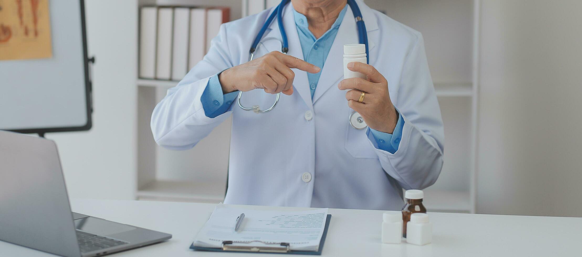 Doctor giving hope. Close up shot of young female physician leaning forward to smiling elderly lady patient holding her hand in palms. Woman caretaker in white coat supporting encouraging old person photo