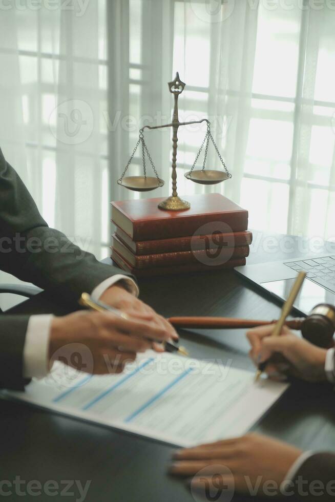Judge gavel with Justice lawyers having team meeting at law firm background. Concepts of Law and Legal services. photo