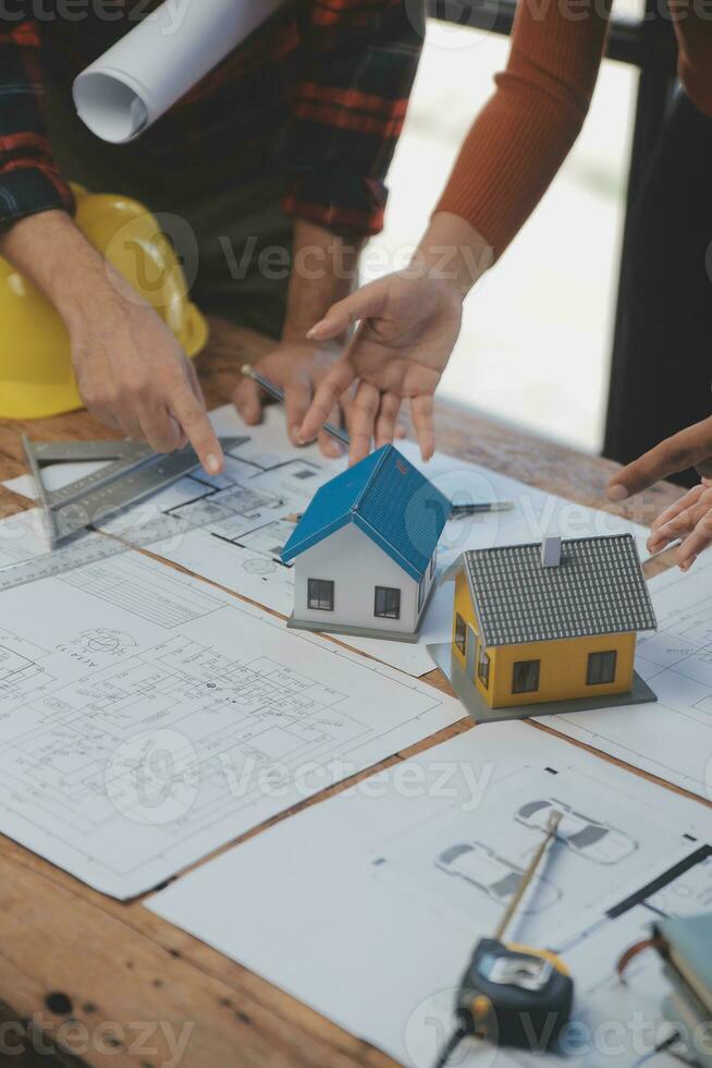 Engineer Teamwork Meeting, Drawing working on blueprint meeting for project working with partner on model building and engineering tools in working site, Construction and structure concept. photo