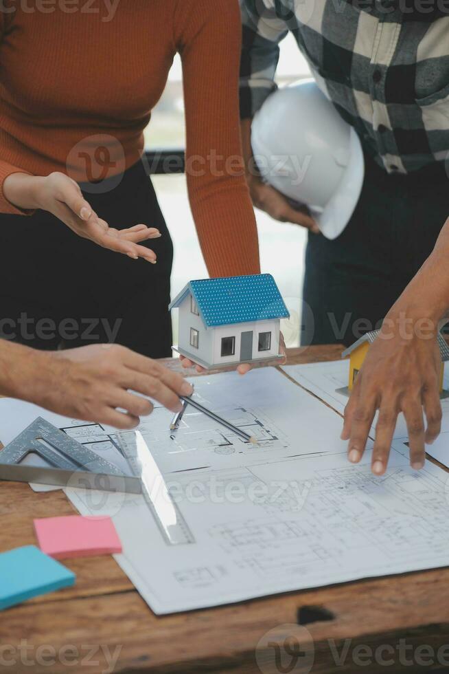 Engineer Teamwork Meeting, Drawing working on blueprint meeting for project working with partner on model building and engineering tools in working site, Construction and structure concept. photo