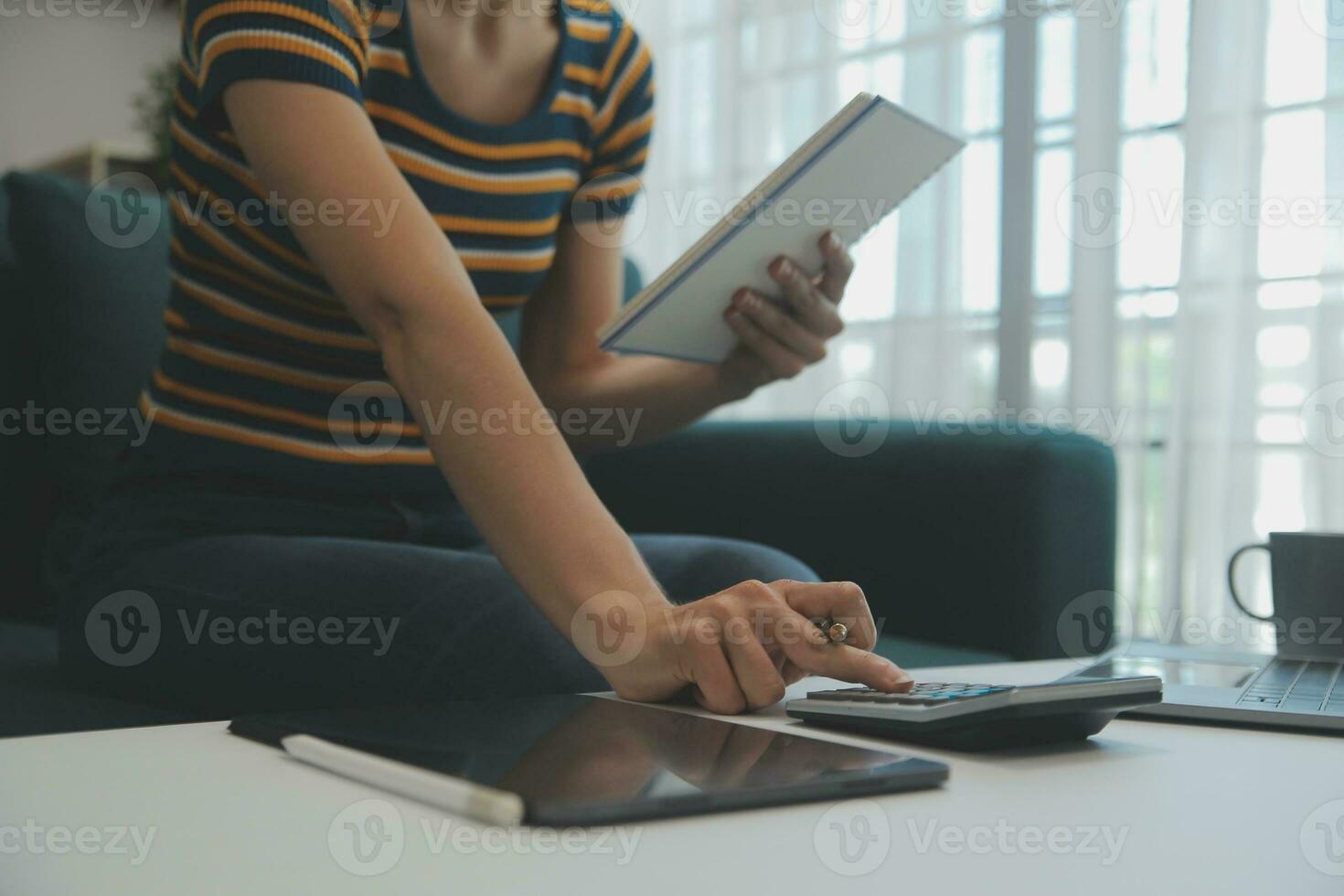 Young adult happy smiling Hispanic Asian student wearing headphones talking on online chat meeting using laptop in university campus or at virtual office. College female student learning remotely. photo