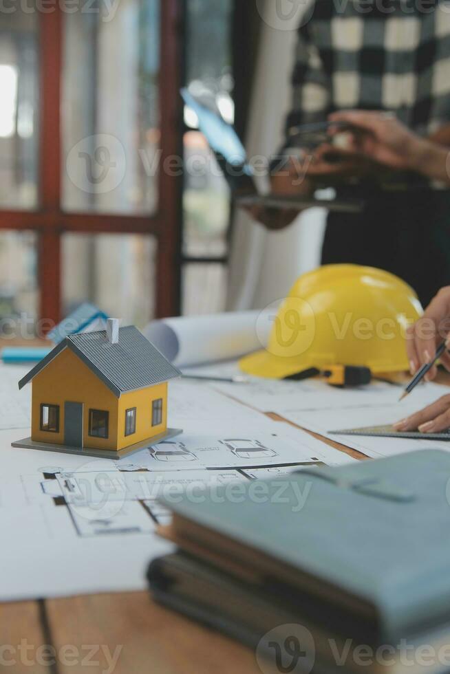 Engineer Teamwork Meeting, Drawing working on blueprint meeting for project working with partner on model building and engineering tools in working site, Construction and structure concept. photo