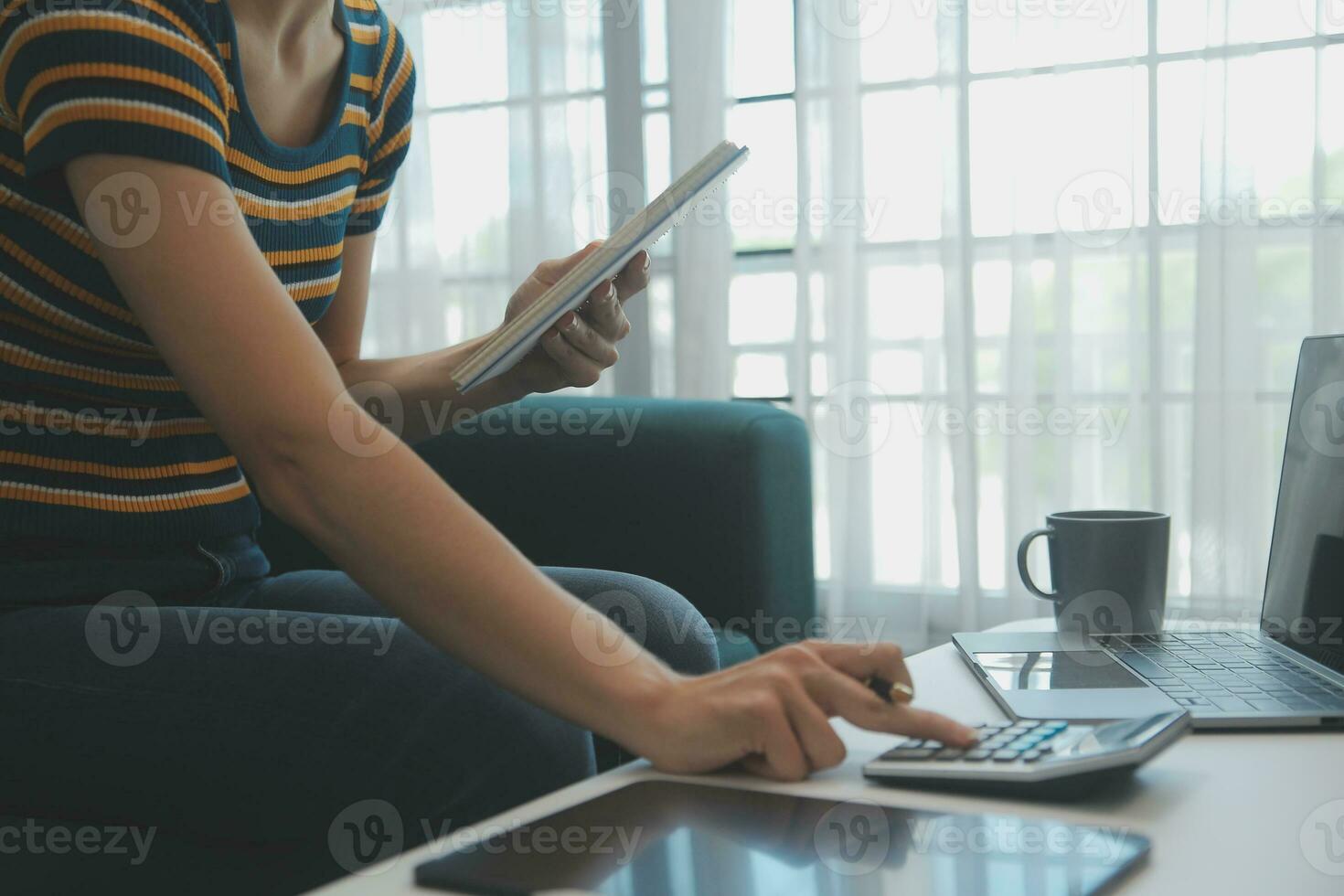 Young adult happy smiling Hispanic Asian student wearing headphones talking on online chat meeting using laptop in university campus or at virtual office. College female student learning remotely. photo