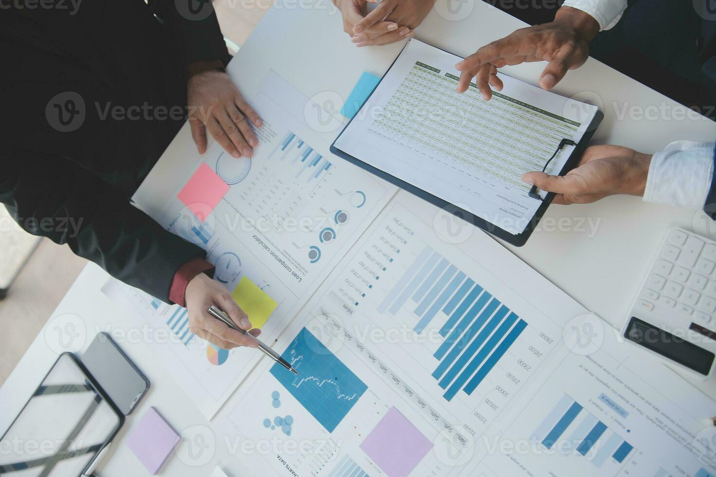 Financial analysts analyze business financial reports on a digital tablet planning investment project during a discussion at a meeting of corporate showing the results of their successful teamwork. photo