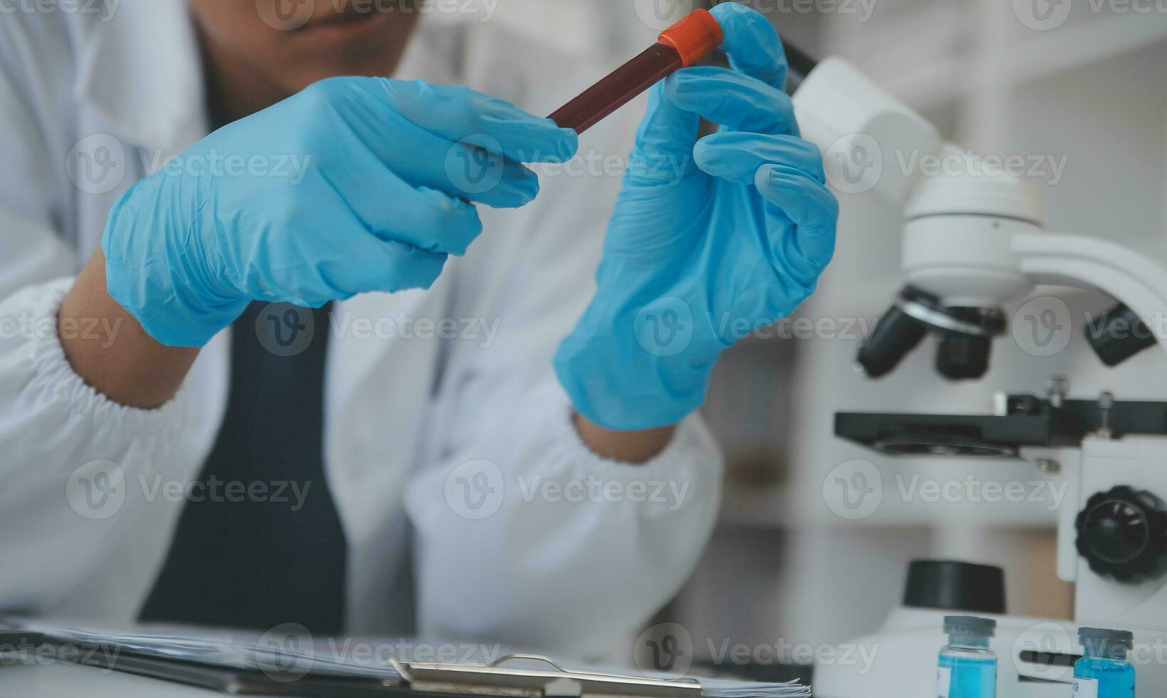 Professional lab. Amazing longhaired medical worker wearing uniform while using microscope during research photo