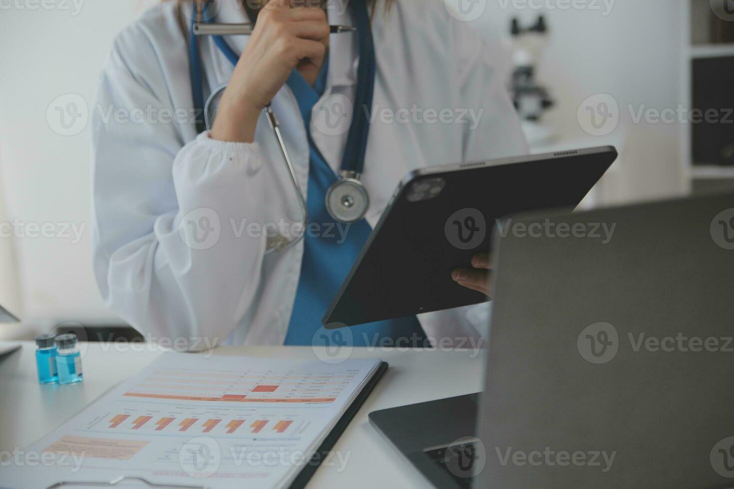 Professional lab. Amazing longhaired medical worker wearing uniform while using microscope during research photo