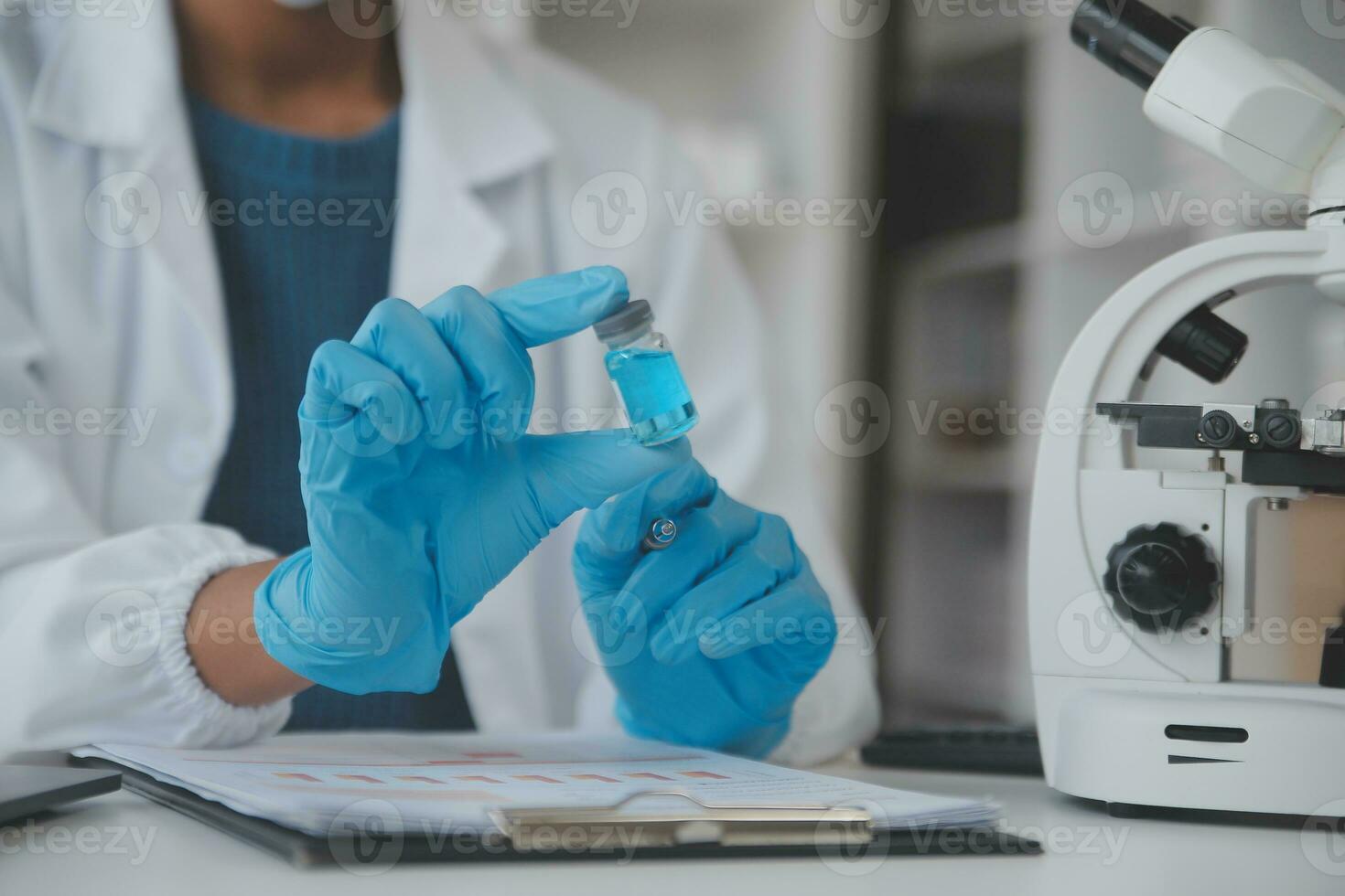 Professional lab. Amazing longhaired medical worker wearing uniform while using microscope during research photo
