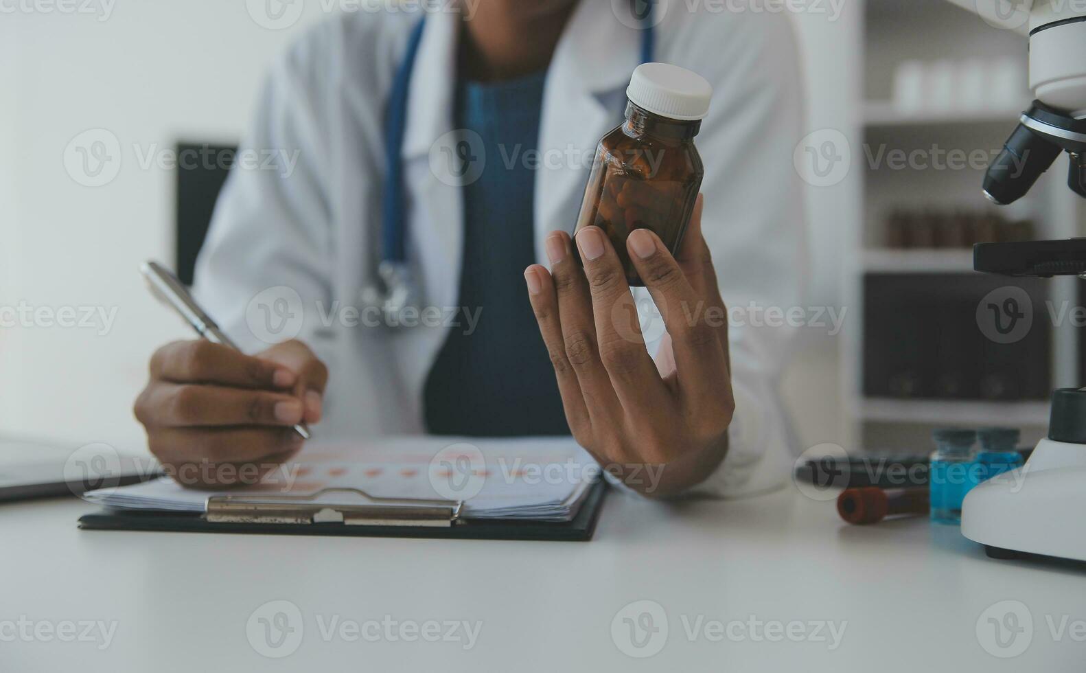 Professional lab. Amazing longhaired medical worker wearing uniform while using microscope during research photo