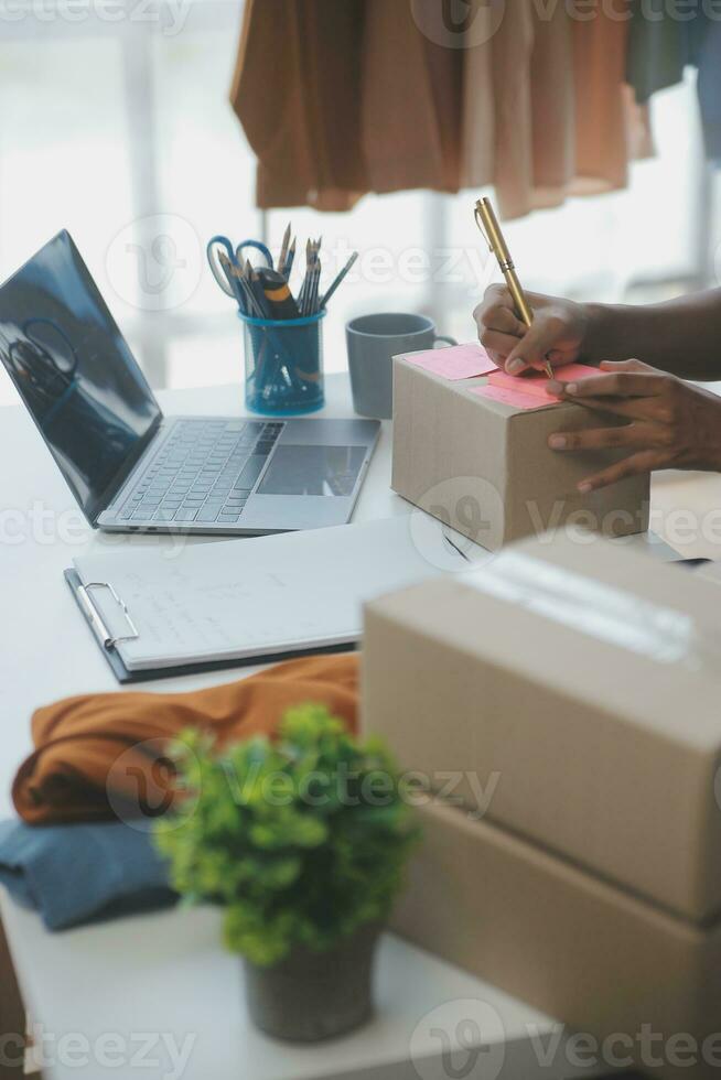 Business woman start up small business entrepreneur SME success .freelance woman working at home with Online Parcel delivery. SME and packaging deliveryconcept photo