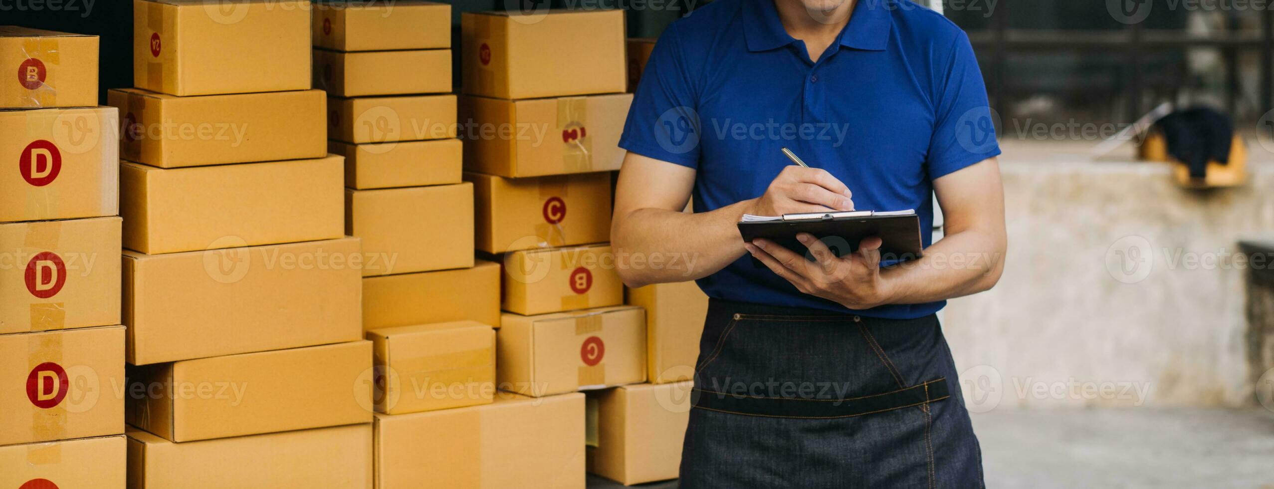 Young woman small business owner online shopping at home. taking note of orders from customers with mobile phones. SME entrepreneur or freelance life style concept. photo