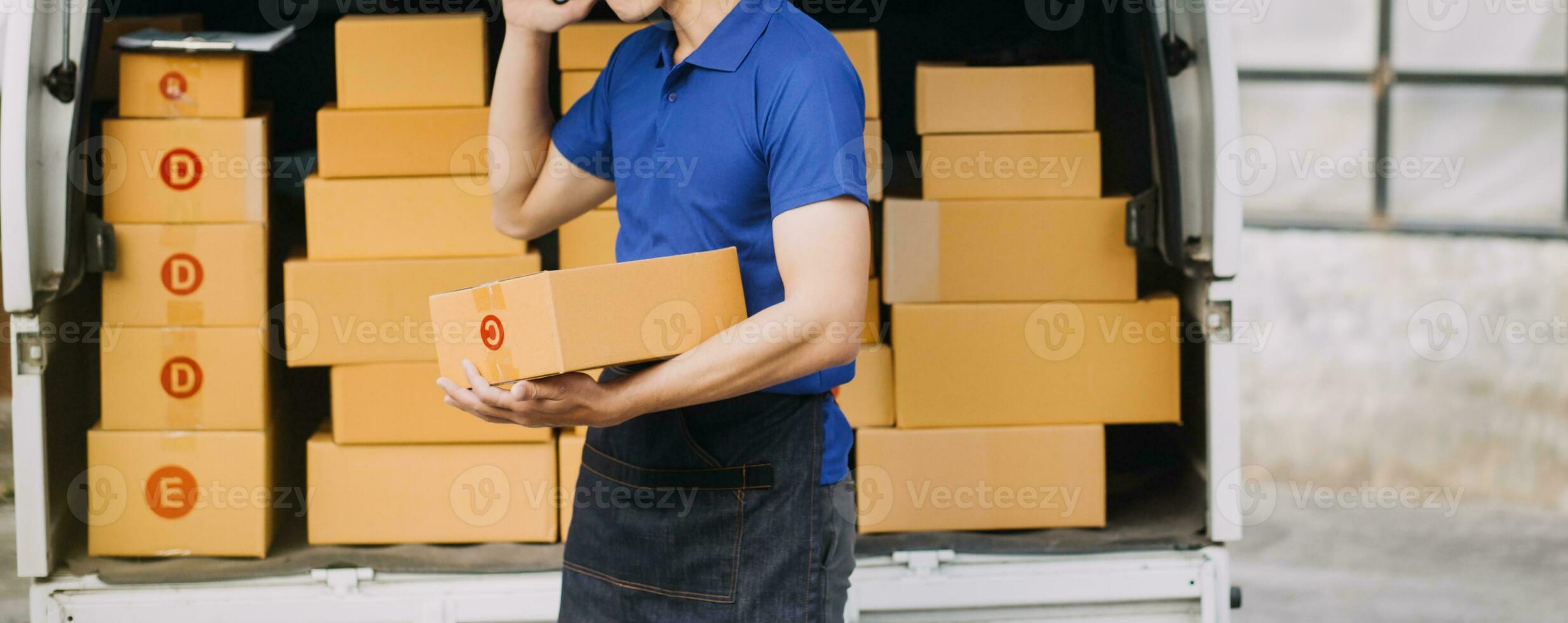 Young woman small business owner online shopping at home. taking note of orders from customers with mobile phones. SME entrepreneur or freelance life style concept. photo