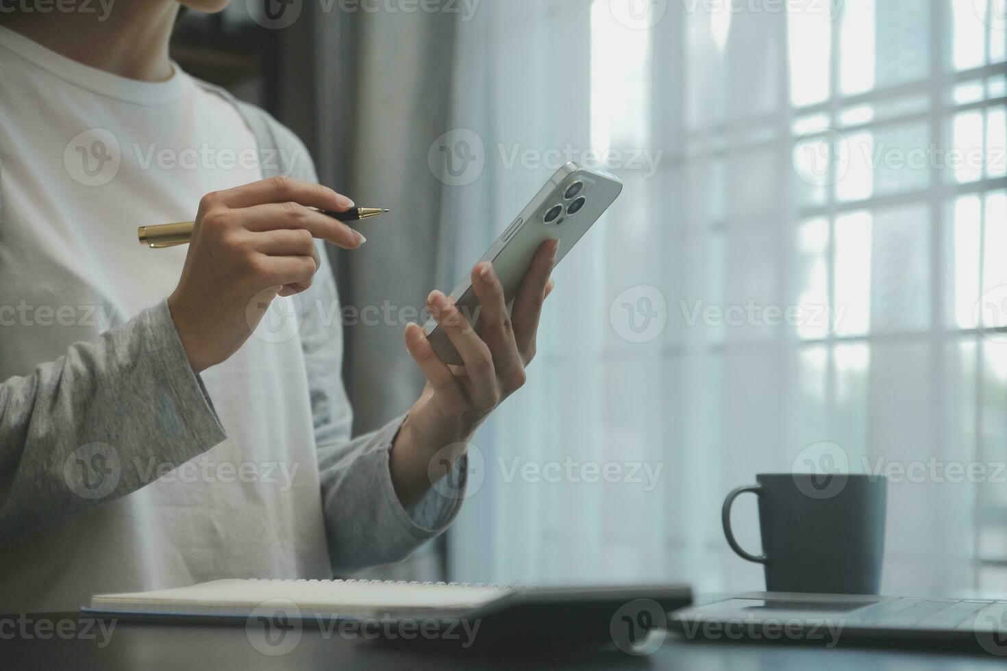 Asian Business woman using calculator and laptop for doing math finance on an office desk, tax, report, accounting, statistics, and analytical research concept photo