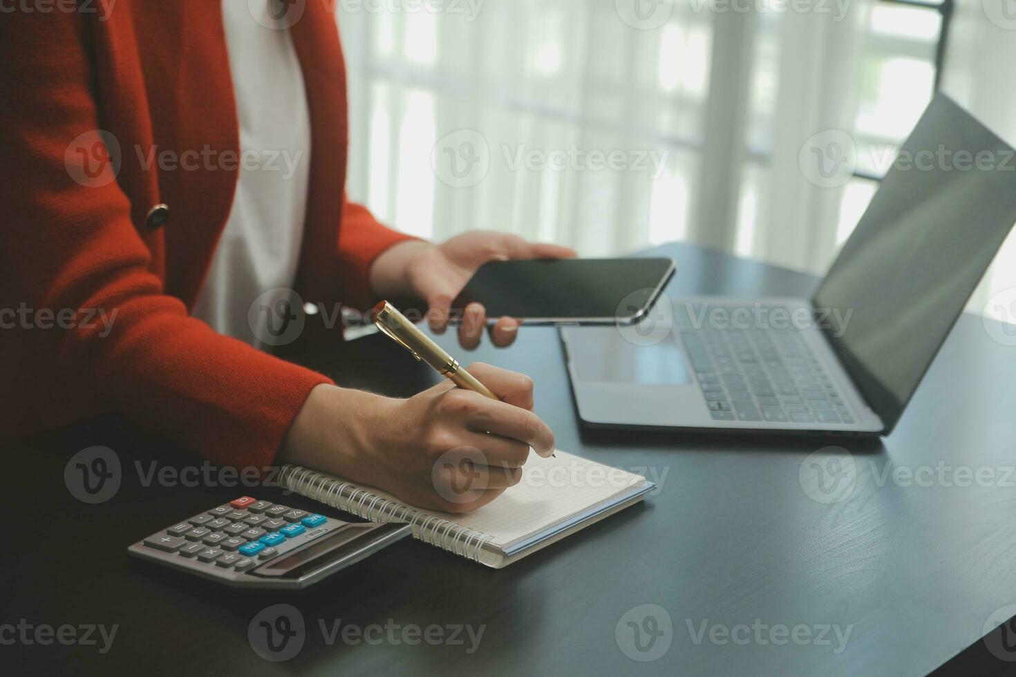 Asian Business woman using calculator and laptop for doing math finance on an office desk, tax, report, accounting, statistics, and analytical research concept photo