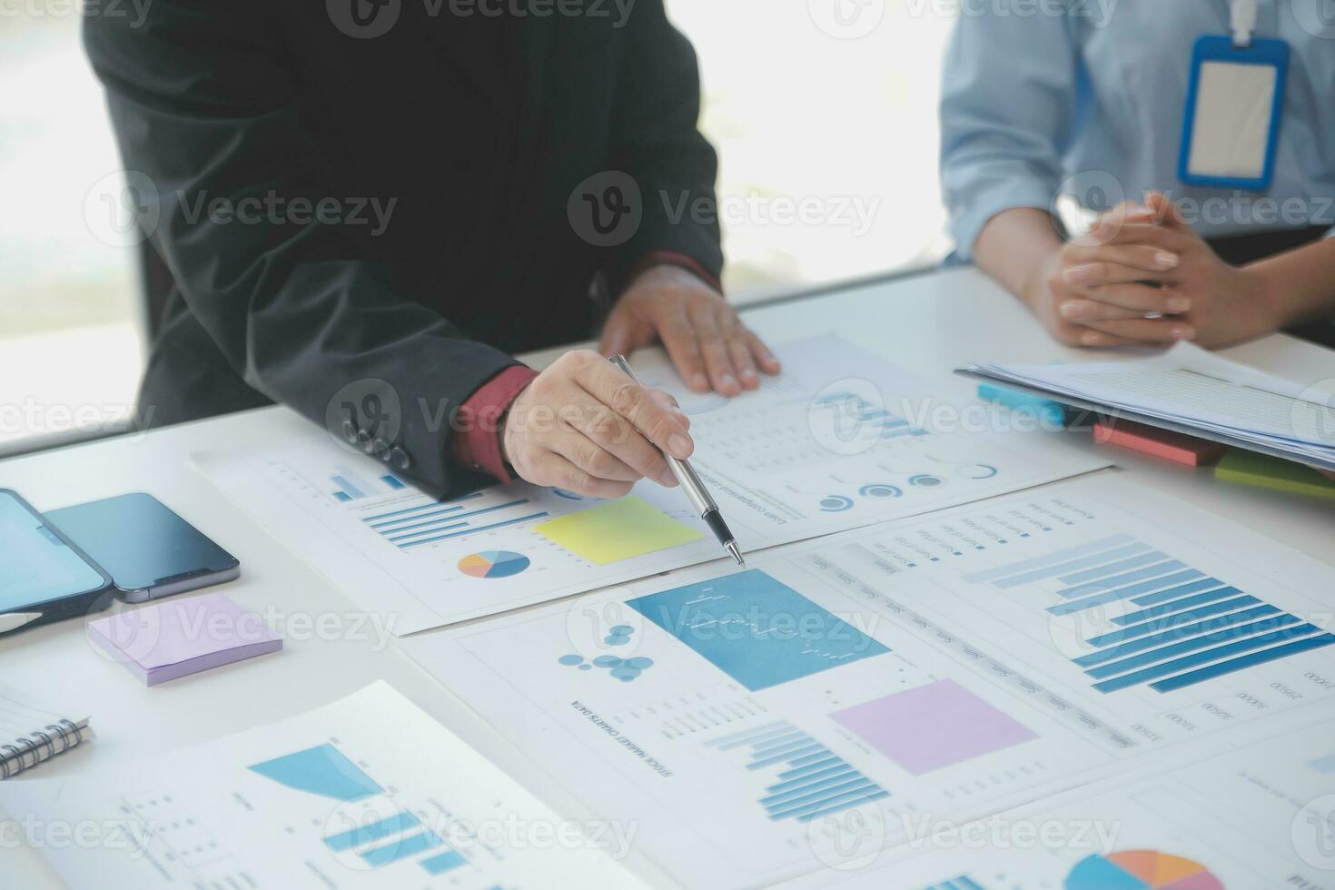 Financial analysts analyze business financial reports on a digital tablet planning investment project during a discussion at a meeting of corporate showing the results of their successful teamwork. photo