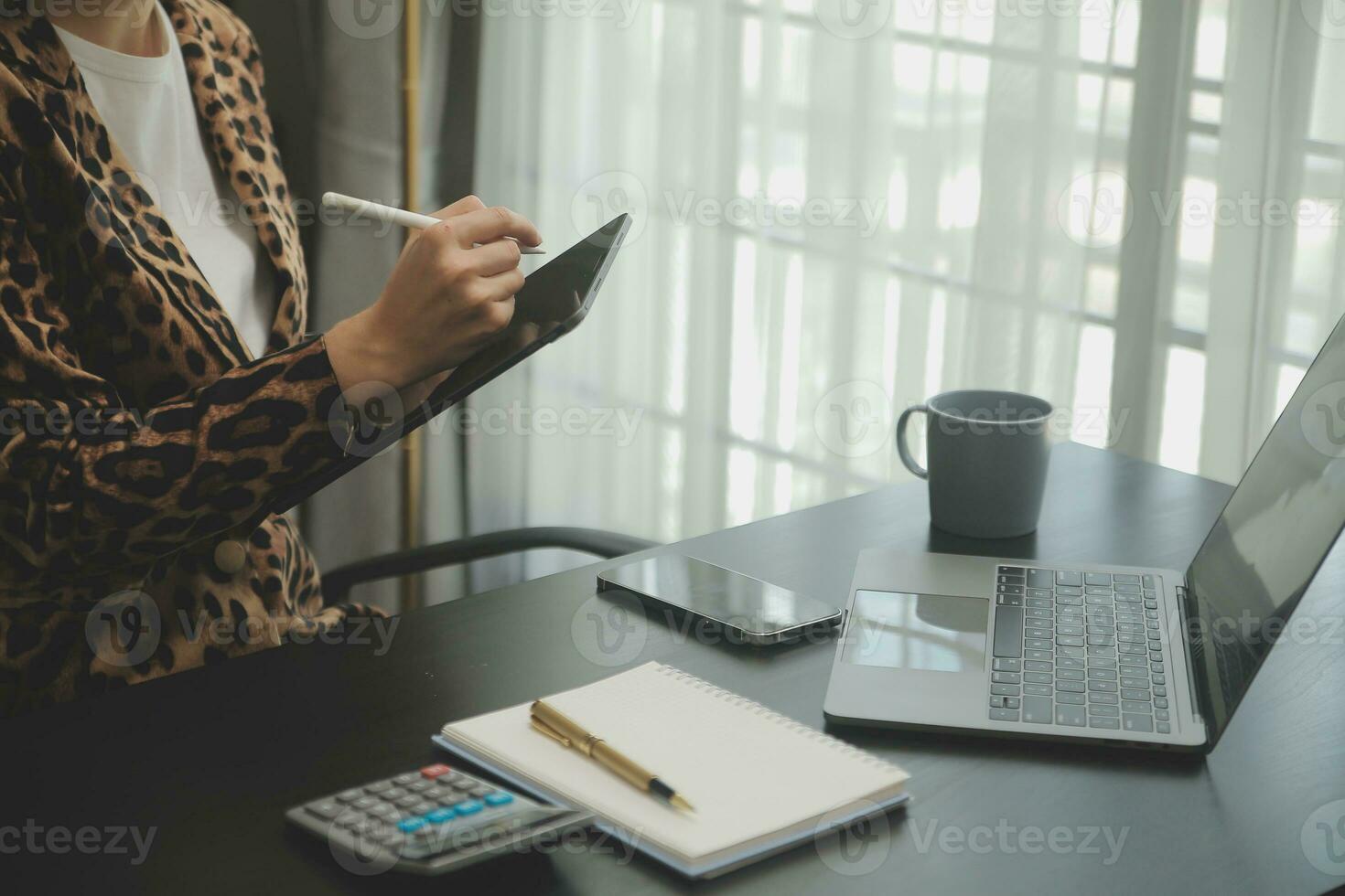 Asian Business woman using calculator and laptop for doing math finance on an office desk, tax, report, accounting, statistics, and analytical research concept photo