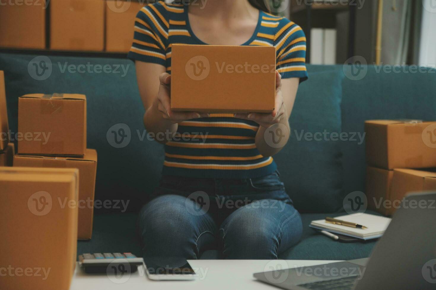 Starting small businesses SME owners female entrepreneurs Write the address on receipt box and check online orders to prepare to pack the boxes, sell to customers, sme business ideas online. photo