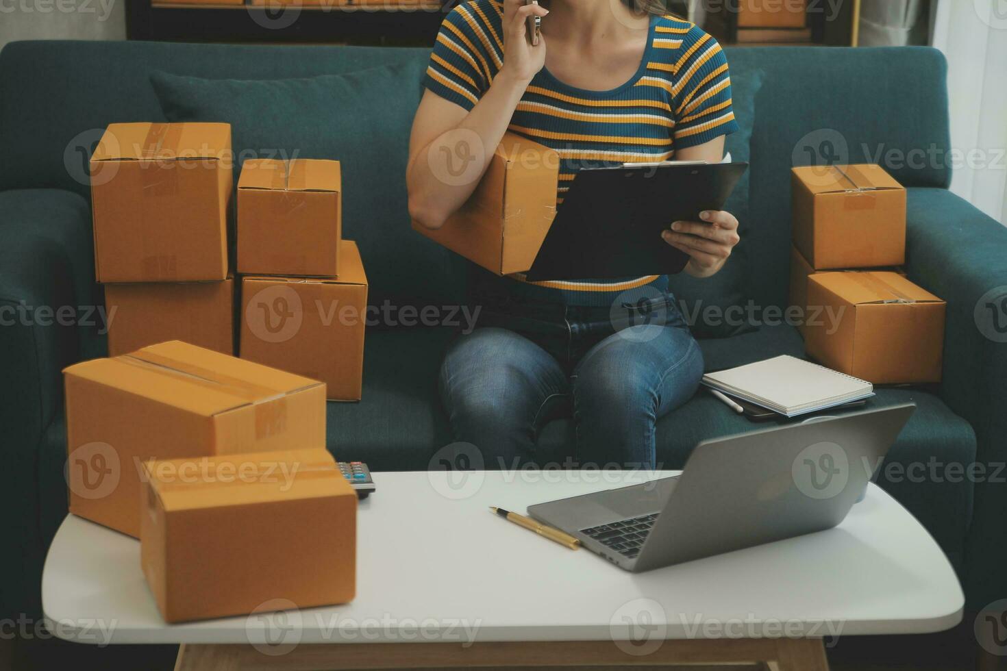 Starting small businesses SME owners female entrepreneurs Write the address on receipt box and check online orders to prepare to pack the boxes, sell to customers, sme business ideas online. photo