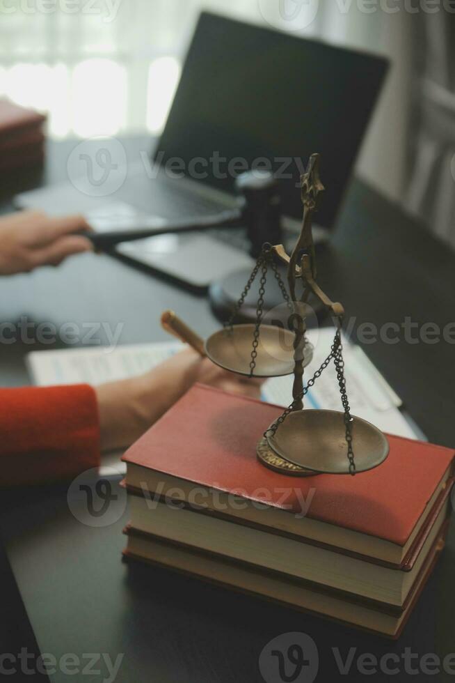 Business and lawyers discussing contract papers with brass scale on desk in office. Law, legal services, advice, justice and law concept picture with film grain effect photo