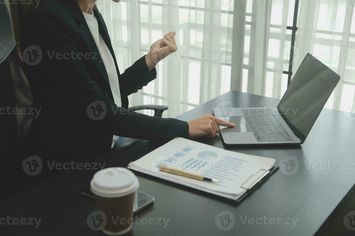 Asian Business woman using calculator and laptop for doing math finance on an office desk, tax, report, accounting, statistics, and analytical research concept photo