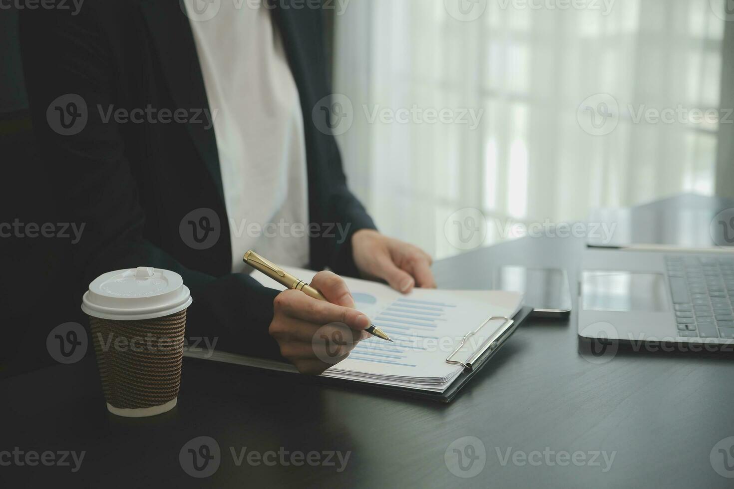 Asian Business woman using calculator and laptop for doing math finance on an office desk, tax, report, accounting, statistics, and analytical research concept photo