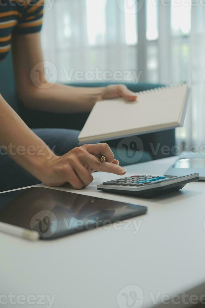 Young adult happy smiling Hispanic Asian student wearing headphones talking on online chat meeting using laptop in university campus or at virtual office. College female student learning remotely. photo
